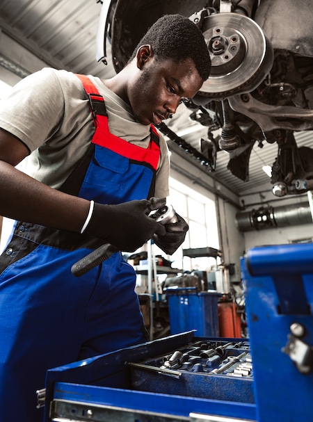 young african mechanic in uniform working in a car 2024 01 15 21 26 40 utc 1